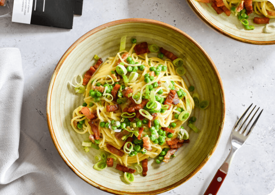 Pasta carbonara met een twist: pancetta en doperwtjes voor een smaaksensatie!